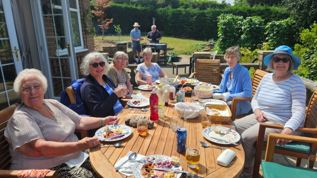 Summer BBQ 2025 - members seated around the table
