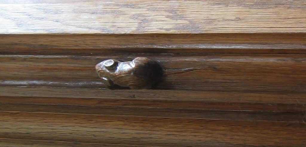 Robert "Mouseman" Thompson's trademark carving on the altar rail in Kilburn Parish Church