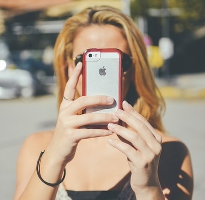 Female using an iPhone to take a photo