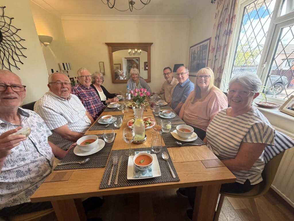 9 people seated at a dining table