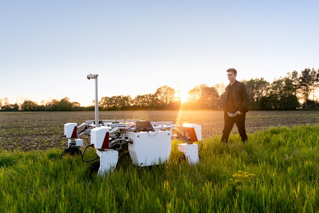 an agricultural robot and engineer in a field