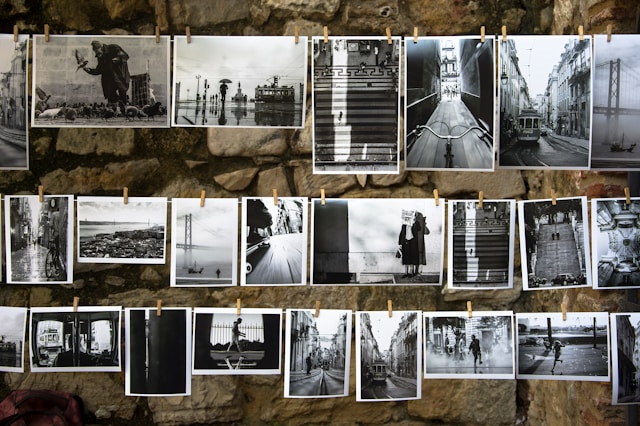black and white photos hanging from strings
