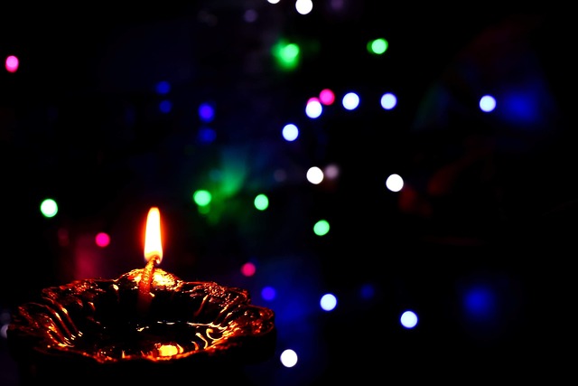 Diwali - lit candle and lights on a dark background