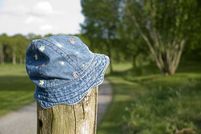 picture of a denim hat on a fence post