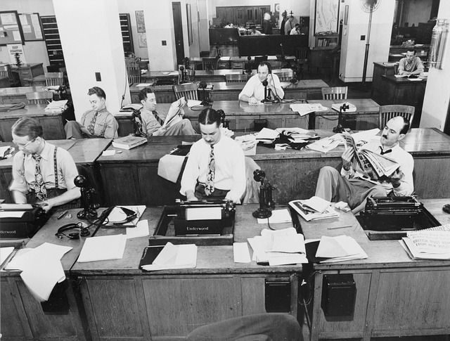 copywriters at desks in the New York Times office