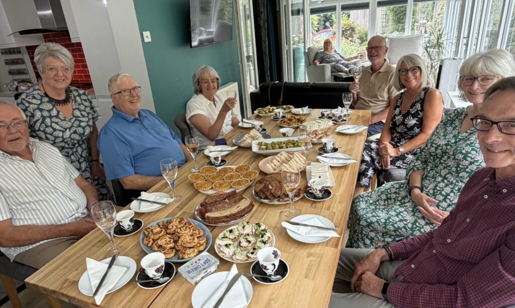 Food & Cookery Group - Afternoon Tea - Group sat around a table laid with food