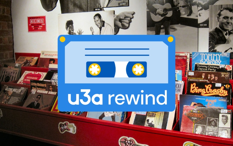 Image of cassette tape superimposed on a display of LP records